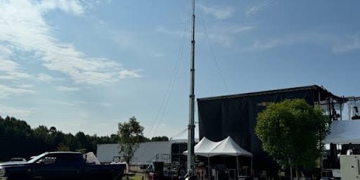 Nov Blog Image A Solaris Technologies Services MITT tower providing reliable, high-speed Wifi connectivity at a bustling outdoor event. The tower stands prominently, ensuring seamless internet access for attendees, vendors, and organizers. A crowd interacts effortlessly online, showcasing the tower's vital role in maintaining connectivity during high-demand moments.