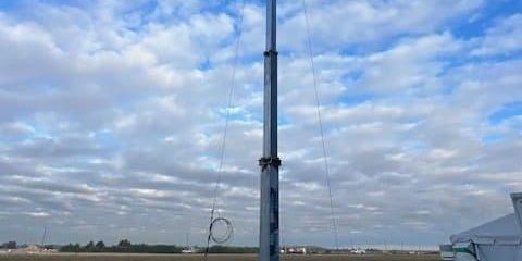 Image of a rural community connected through broadband, featuring students accessing online education, farmers using technology, and telehealth services.