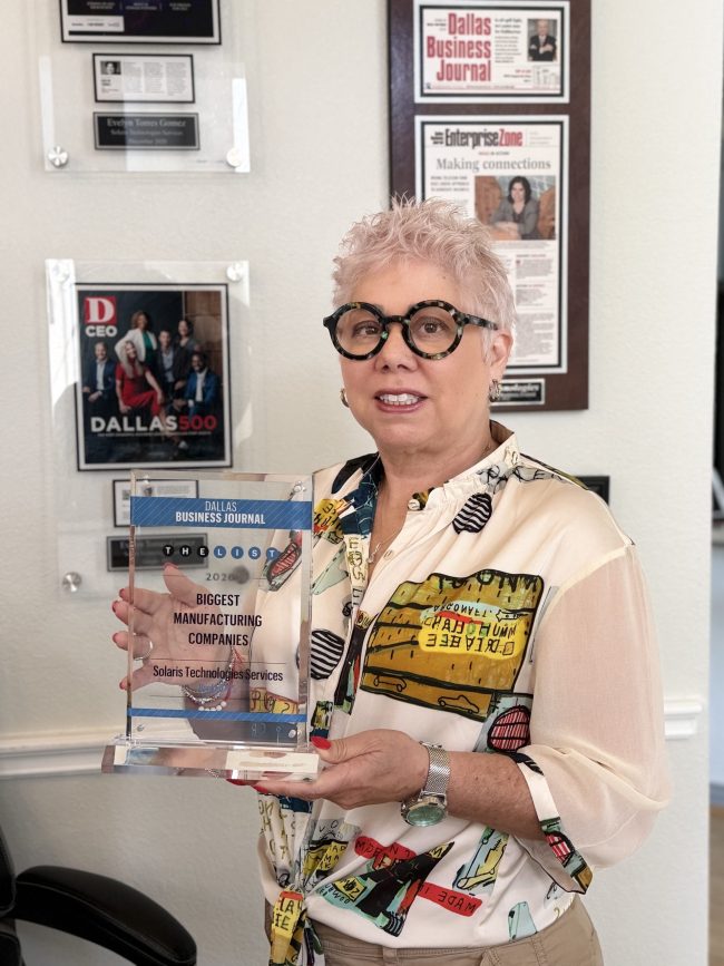 Evelyn Torres, CEO and President of Solaris Technologies Services, proudly displays her industry award recognizing leadership and innovation in telecommunications infrastructure manufacturing.